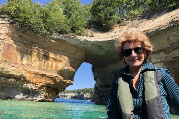 Senator Debbie Stabenow in a boat in the water in front of Pictured Rocks