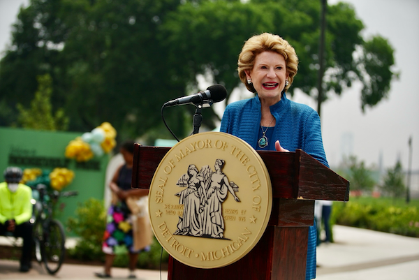 Debbie Stabenow speaking at a podium that says Seal of Mayor of the City of Detroit Michigan