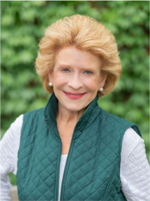 High-resolution photo of Senator Debbie Stabenow in a green vest